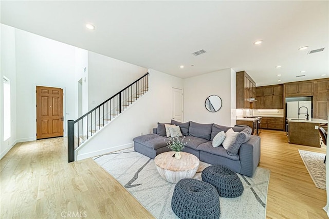 20754 W Bur Oak Cir, Porter Ranch, CA 91326 - living area featuring stairs, light wood-style flooring, and recessed lighting