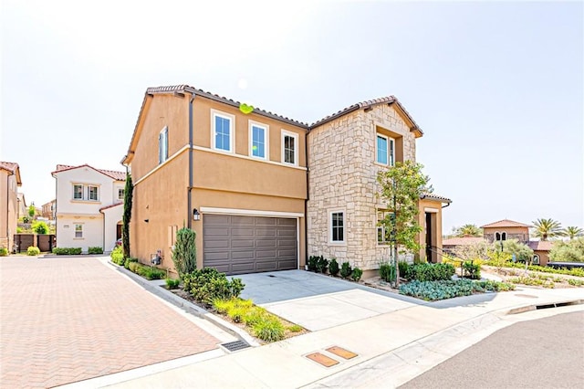 20754 W Bur Oak Cir, Porter Ranch, CA 91326 - view of front of property with concrete driveway, a garage, stucco siding, and stone siding