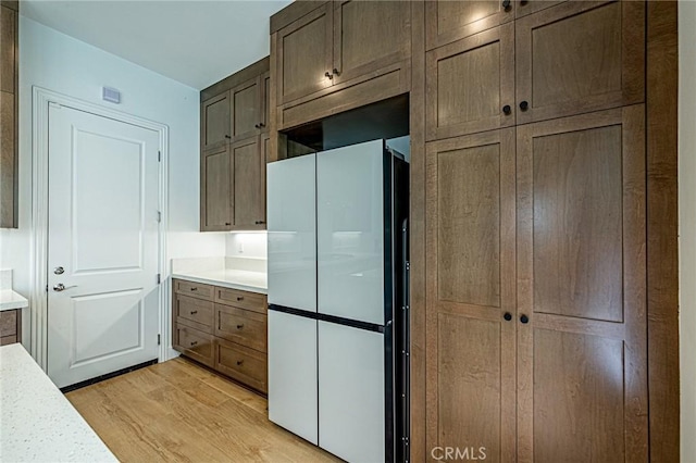 20754 W Bur Oak Cir, Porter Ranch, CA 91326 - kitchen with freestanding refrigerator, light wood-style floors, and light countertops