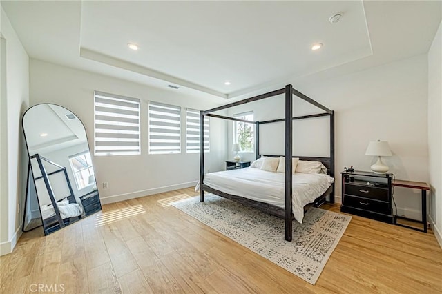 20754 W Bur Oak Cir, Porter Ranch, CA 91326 - bedroom with a tray ceiling, multiple windows, light wood-type flooring, and recessed lighting