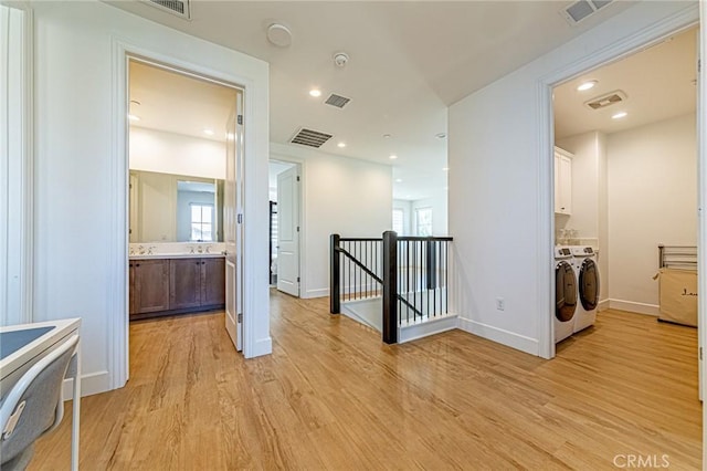 20754 W Bur Oak Cir, Porter Ranch, CA 91326 - hallway featuring an upstairs landing, washing machine and clothes dryer, light wood finished floors, and recessed lighting