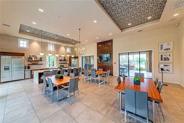20754 W Bur Oak Cir, Porter Ranch, CA 91326 - dining area featuring a tray ceiling, a towering ceiling, recessed lighting, a chandelier, and light tile patterned flooring