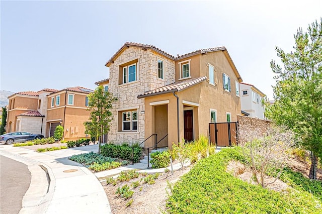 20754 W Bur Oak Cir, Porter Ranch, CA 91326 - view of front of home featuring stone siding, stucco siding, and a tiled roof