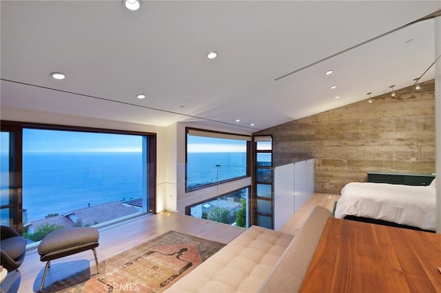 2517 Iris Way, Laguna Beach, CA 92651 - bedroom featuring lofted ceiling, wooden walls, recessed lighting, a water view, and wood finished floors
