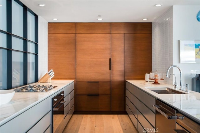 2517 Iris Way, Laguna Beach, CA 92651 - kitchen with stainless steel appliances, light stone countertops, light wood-type flooring, recessed lighting, and brown cabinets