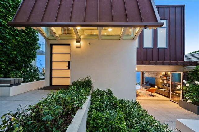 2517 Iris Way, Laguna Beach, CA 92651 - doorway to property featuring board and batten siding, a patio, and stucco siding