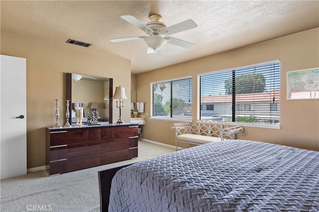 60545 Montecito Dr Unit 5, Palm Springs, CA 92264 - bedroom featuring light carpet, a textured ceiling, and ceiling fan