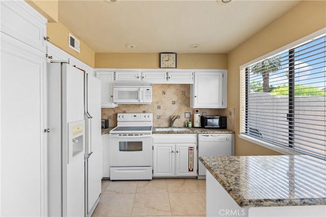 60545 Montecito Dr Unit 5, Palm Springs, CA 92264 - kitchen featuring white appliances, white cabinetry, light tile patterned floors, backsplash, and stone countertops