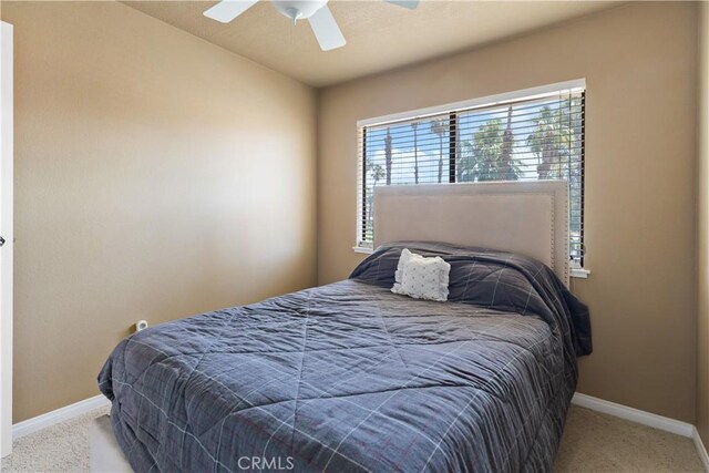 60545 Montecito Dr Unit 5, Palm Springs, CA 92264 - carpeted bedroom featuring baseboards and a ceiling fan