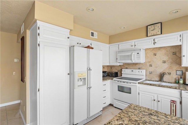 60545 Montecito Dr Unit 5, Palm Springs, CA 92264 - kitchen with white appliances, decorative backsplash, white cabinetry, and light stone countertops