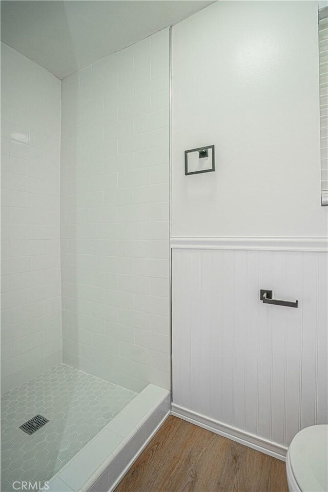 18259 Midbury St, Brea, CA 92821 - full bath featuring wood finished floors, tiled shower, and wainscoting