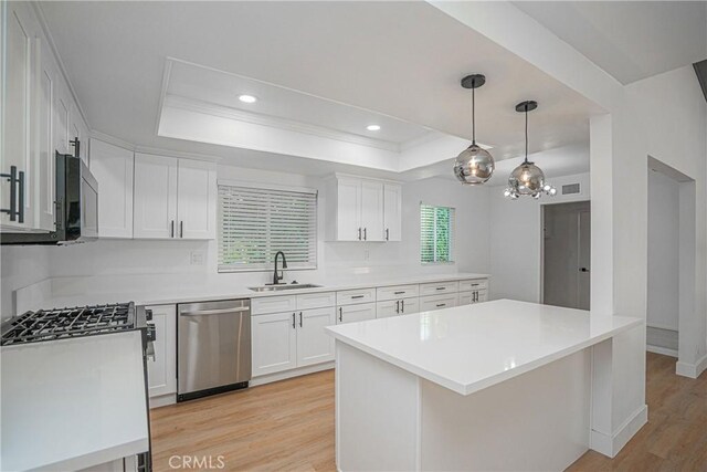 18259 Midbury St, Brea, CA 92821 - kitchen with dishwasher, a tray ceiling, light wood finished floors, white cabinetry, and ornamental molding