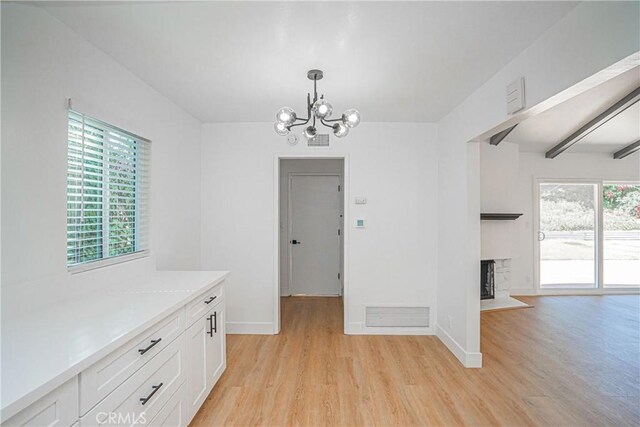 18259 Midbury St, Brea, CA 92821 - unfurnished dining area featuring light wood-type flooring, a chandelier, and a fireplace