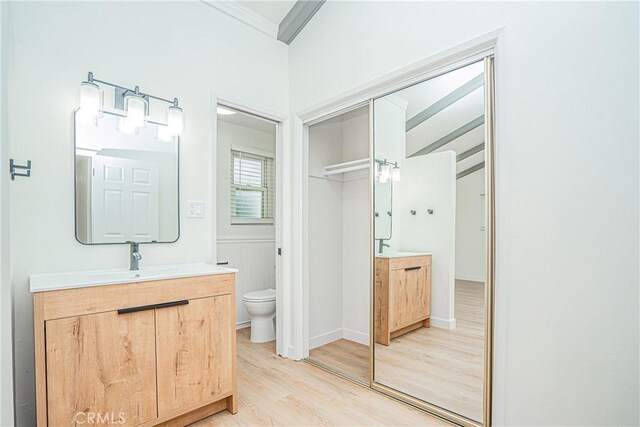 18259 Midbury St, Brea, CA 92821 - bathroom with wood finished floors, two vanities, and crown molding