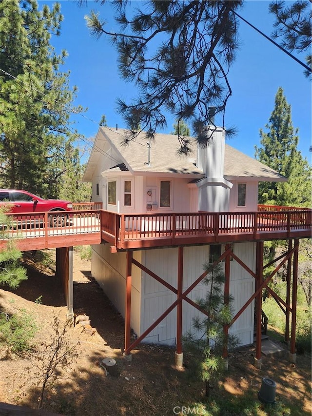 530 Villa Grove Ave, Big Bear City, CA 92314 - rear view of house featuring a wooden deck and a shingled roof