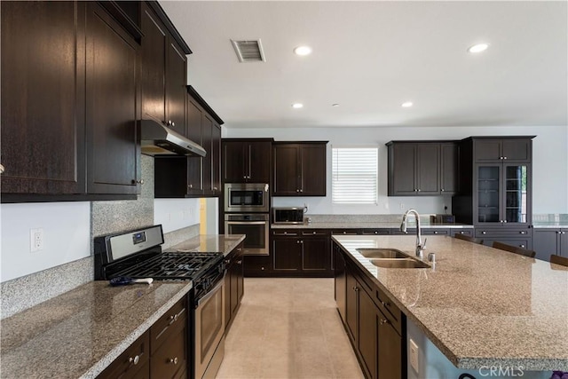 34901 Limecrest Pl, Murrieta, CA 92563 - kitchen with appliances with stainless steel finishes, under cabinet range hood, a sink, recessed lighting, and a center island with sink