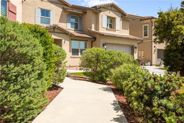 34901 Limecrest Pl, Murrieta, CA 92563 - view of property featuring a garage, stucco siding, and a tiled roof