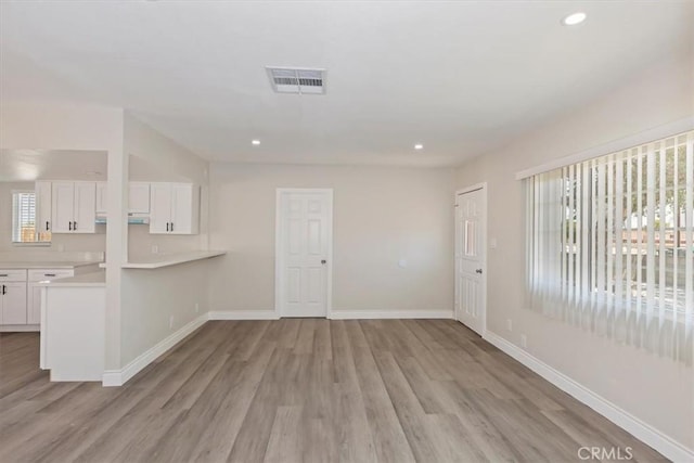 35010 Cedar Rd, Barstow, CA 92311 - unfurnished living room featuring light wood-style flooring, recessed lighting, and baseboards
