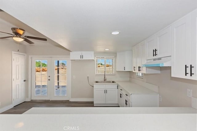 35010 Cedar Rd, Barstow, CA 92311 - kitchen with under cabinet range hood, a sink, recessed lighting, white cabinetry, and baseboards