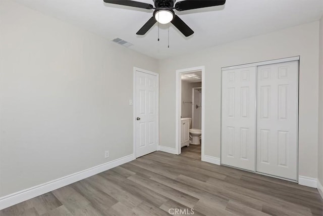 35010 Cedar Rd, Barstow, CA 92311 - unfurnished bedroom featuring wood finished floors, baseboards, connected bathroom, and a closet