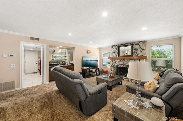 1938 N Quince Way, Upland, CA 91784 - living room featuring light colored carpet, crown molding, recessed lighting, a textured ceiling, and a stone fireplace