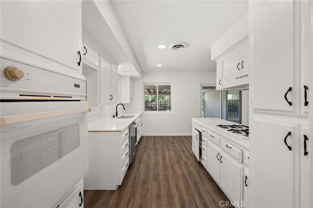3221 W Jacinto View Rd, Banning, CA 92220 - kitchen featuring white appliances, light countertops, dark wood finished floors, white cabinets, and recessed lighting