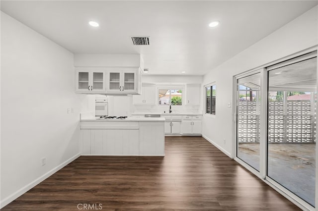 3221 W Jacinto View Rd, Banning, CA 92220 - kitchen featuring a peninsula, white appliances, white cabinets, a sink, and glass insert cabinets
