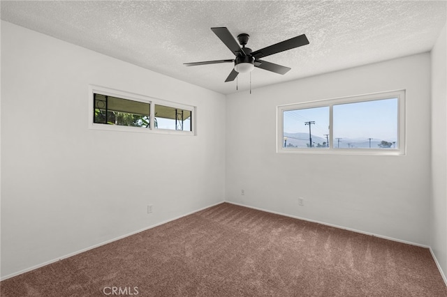 3221 W Jacinto View Rd, Banning, CA 92220 - spare room featuring carpet floors, ceiling fan, baseboards, and a textured ceiling