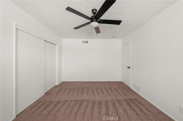 3221 W Jacinto View Rd, Banning, CA 92220 - unfurnished bedroom featuring a textured ceiling, carpet flooring, a closet, and a ceiling fan