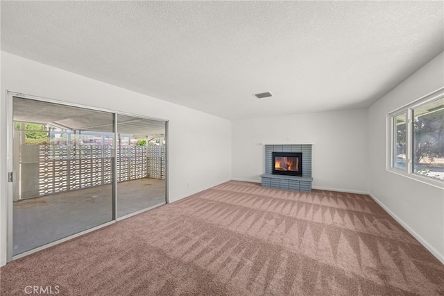 3221 W Jacinto View Rd, Banning, CA 92220 - unfurnished living room with carpet, a fireplace, a textured ceiling, and baseboards