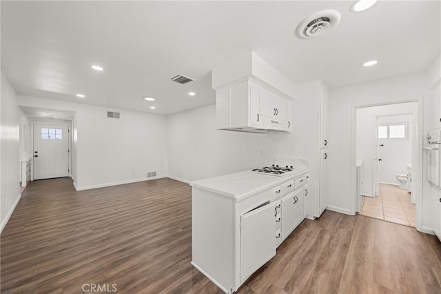 3221 W Jacinto View Rd, Banning, CA 92220 - kitchen with white cabinets, dark wood-style flooring, light countertops, white gas stovetop, and recessed lighting