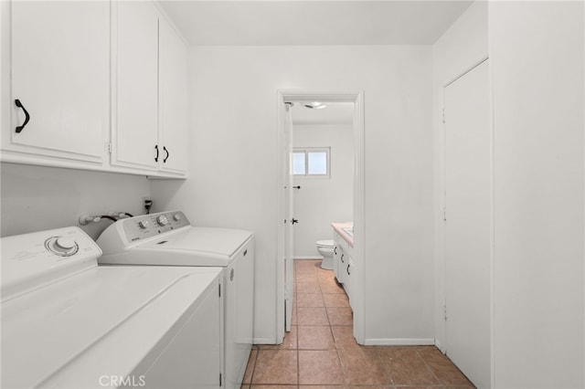3221 W Jacinto View Rd, Banning, CA 92220 - laundry room with washing machine and clothes dryer, cabinet space, light tile patterned flooring, and baseboards