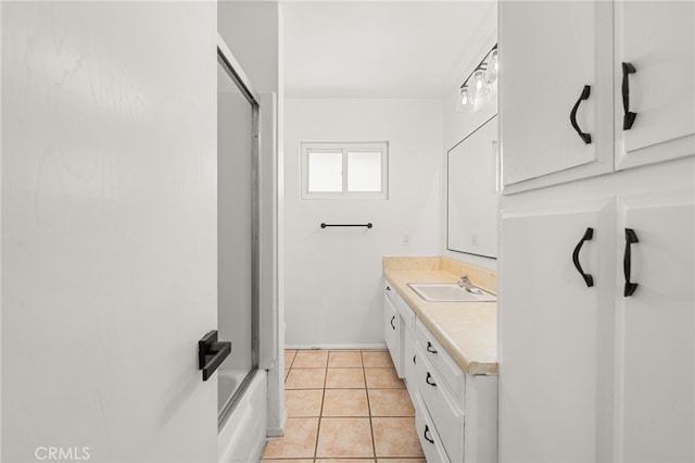 3221 W Jacinto View Rd, Banning, CA 92220 - bathroom with vanity, tile patterned flooring, baseboards, and enclosed tub / shower combo
