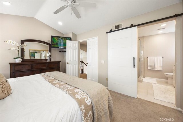 5020 Windy Cir, Yorba Linda, CA 92887 - bedroom featuring a barn door, carpet floors, vaulted ceiling, recessed lighting, and ensuite bathroom