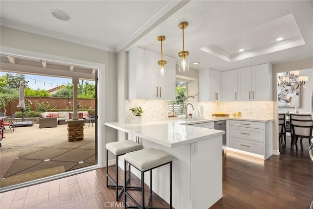 5020 Windy Cir, Yorba Linda, CA 92887 - kitchen featuring a kitchen breakfast bar, a sink, white cabinets, ornamental molding, and dark wood finished floors