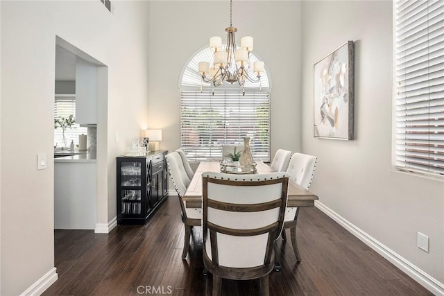 5020 Windy Cir, Yorba Linda, CA 92887 - dining room featuring a chandelier, dark wood-style flooring, baseboards, and a towering ceiling