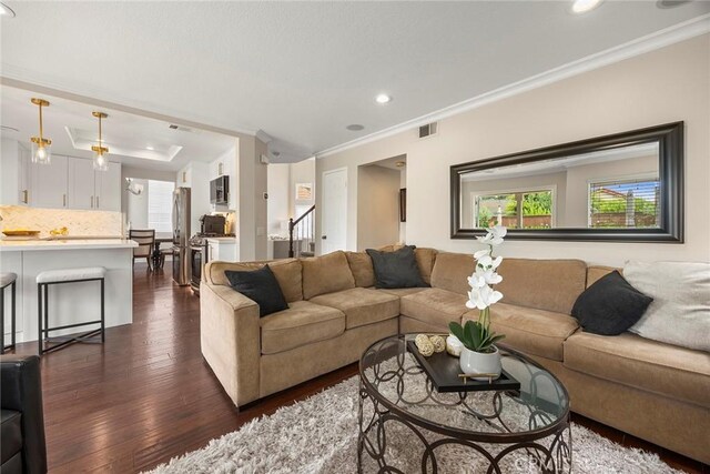 5020 Windy Cir, Yorba Linda, CA 92887 - living room with recessed lighting, dark wood-type flooring, crown molding, a tray ceiling, and stairs