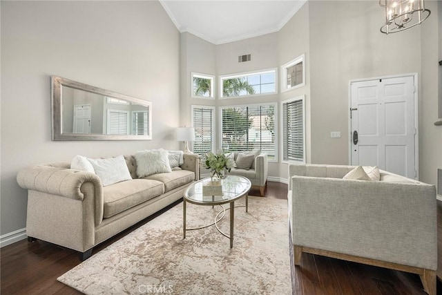 5020 Windy Cir, Yorba Linda, CA 92887 - living area featuring crown molding, baseboards, dark wood-style flooring, a high ceiling, and a chandelier