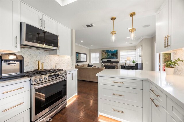 5020 Windy Cir, Yorba Linda, CA 92887 - kitchen featuring stainless steel appliances, ornamental molding, a peninsula, backsplash, and white cabinets