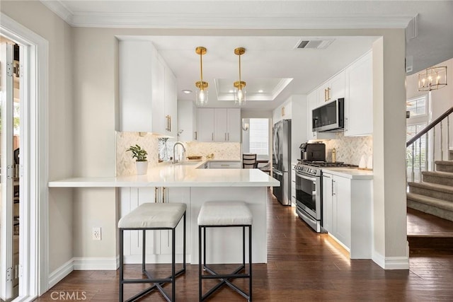5020 Windy Cir, Yorba Linda, CA 92887 - kitchen with appliances with stainless steel finishes, a sink, dark wood-type flooring, a peninsula, and crown molding