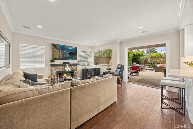5020 Windy Cir, Yorba Linda, CA 92887 - living room featuring dark wood-style floors, a stone fireplace, crown molding, and recessed lighting
