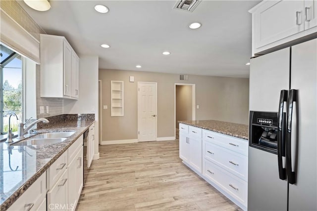 2241 Cordero Ave, Simi Valley, CA 93065 - kitchen with appliances with stainless steel finishes, white cabinetry, recessed lighting, light wood finished floors, and dark stone counters