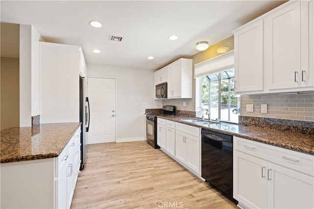 2241 Cordero Ave, Simi Valley, CA 93065 - kitchen with black appliances, light wood finished floors, white cabinets, dark stone countertops, and tasteful backsplash