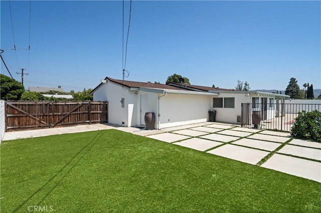 2241 Cordero Ave, Simi Valley, CA 93065 - rear view of house featuring a patio, a fenced backyard, and a gate