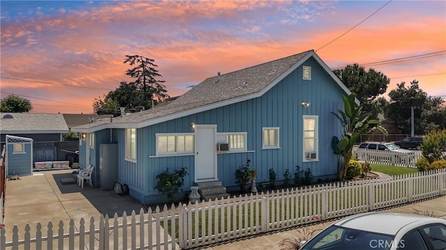 382 N Palomares St, Pomona, CA 91767 - view of front of home with entry steps, a fenced front yard, and a shingled roof