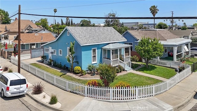 382 N Palomares St, Pomona, CA 91767 - view of front facade with a fenced front yard, a shingled roof, and a residential view