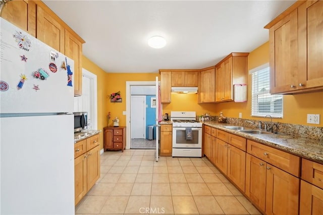 382 N Palomares St, Pomona, CA 91767 - kitchen featuring white appliances, under cabinet range hood, light tile patterned flooring, and brown cabinetry