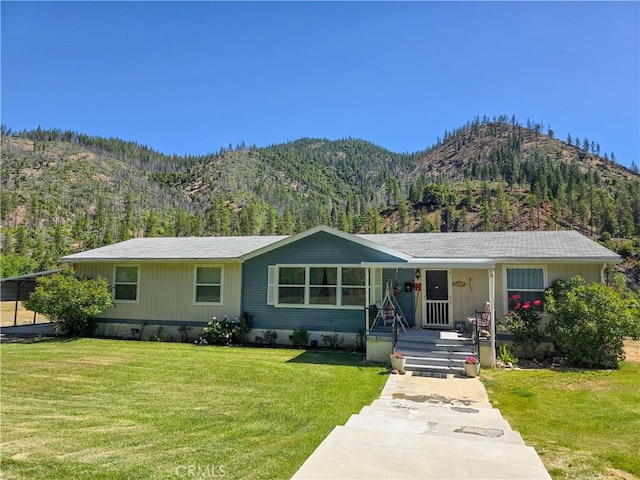 38727 State Highway 96, Klamath River, CA 96050 - view of front facade with covered porch, a mountain view, and a front lawn