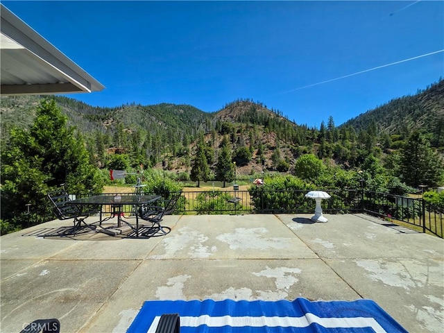 38727 State Highway 96, Klamath River, CA 96050 - view of patio / terrace with a mountain view, outdoor dining space, and a forest view