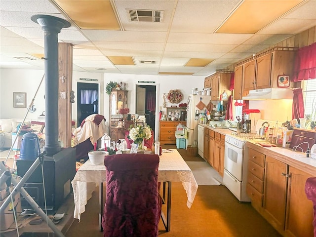 38727 State Highway 96, Klamath River, CA 96050 - kitchen with light countertops, under cabinet range hood, white appliances, a drop ceiling, and brown cabinetry